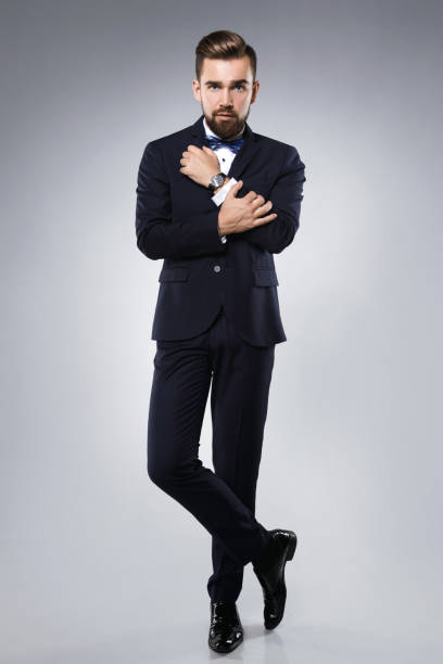 istock Stylish handsome man wearing a classic suit with bow-tie 996237424