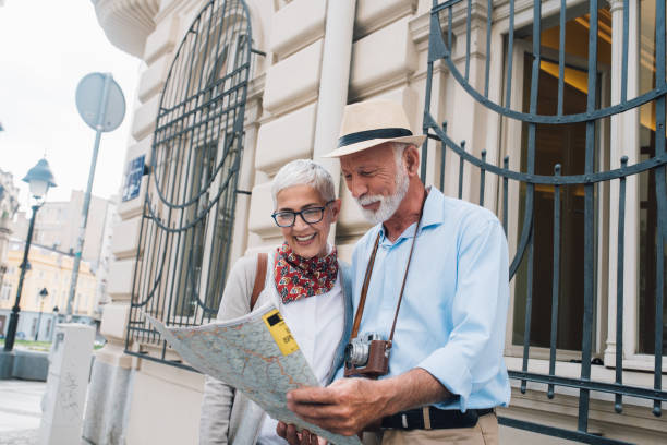 istock Elderly couple on vacation looking at the map 996237446