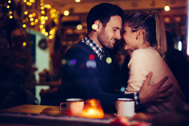 istock Romantic couple dating in pub at night 996237470