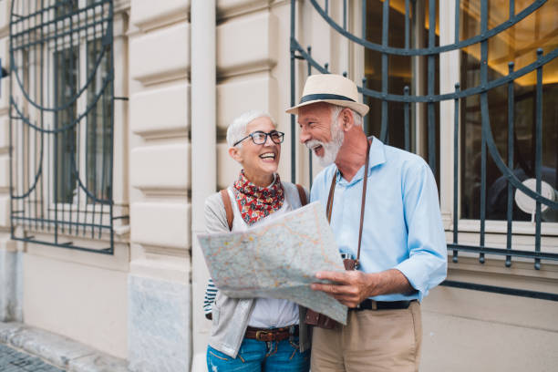istock Happy couple with the map in their hands smiling 996237492