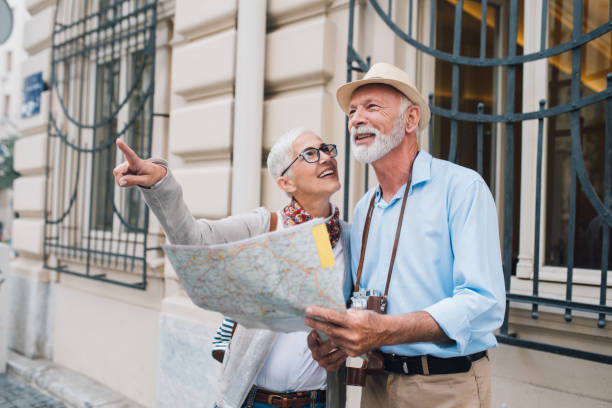 istock Mature woman pointing direction to older tourist 996237498