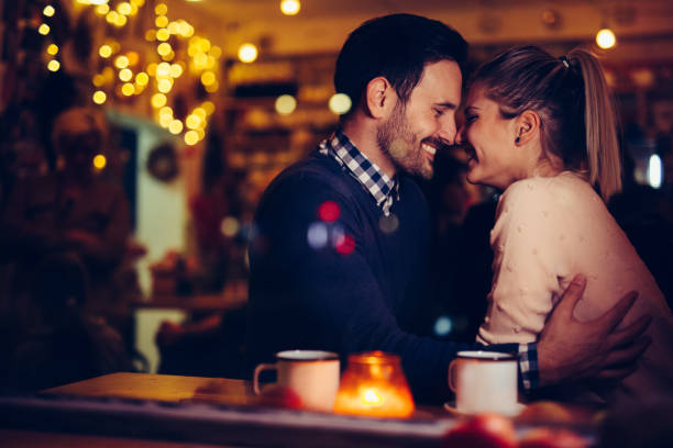 istock Romantic couple dating in pub at night 996237506