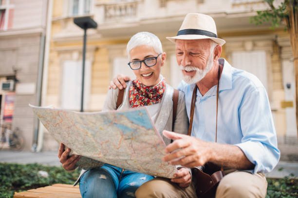 istock Happy tourists looking at the map 996237726