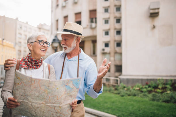 istock Elderly man talking to the woman holding a map 996238142