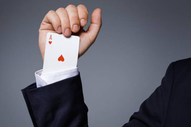 man is hiding an ace in the sleeve - magic trick imagens e fotografias de stock
