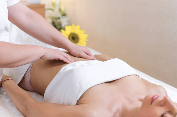 Cute young woman enjoying during a skin care treatment at a spa.