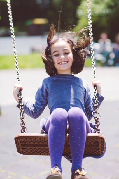 istock Girl swinging in the park 996244954