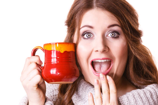 istock Woman holding red tea coffee mug 996245278