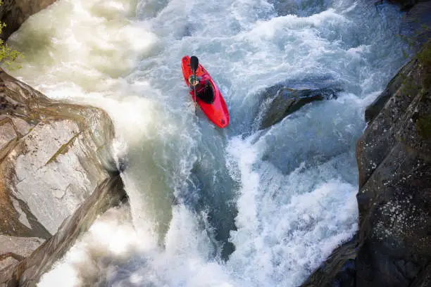 High-angle shot of a man running whitewater rapids in Austria.