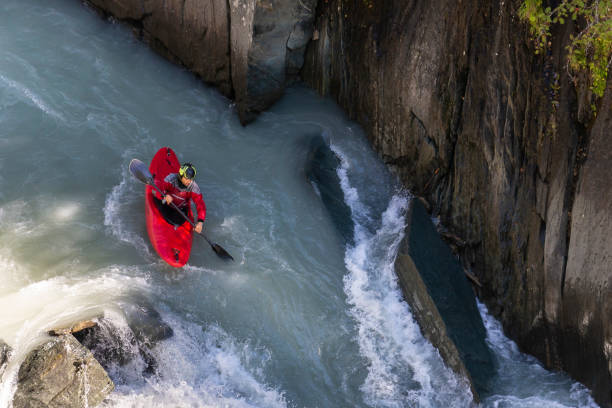 istock Running whitewater rapids with red kayak 996245990