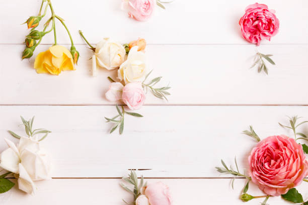 istock Festive flower composition on the white wooden background. Overh 996246548