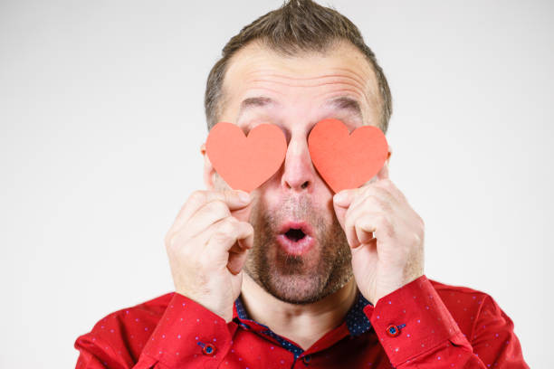 istock Man in love with hearts on eyes 996246898