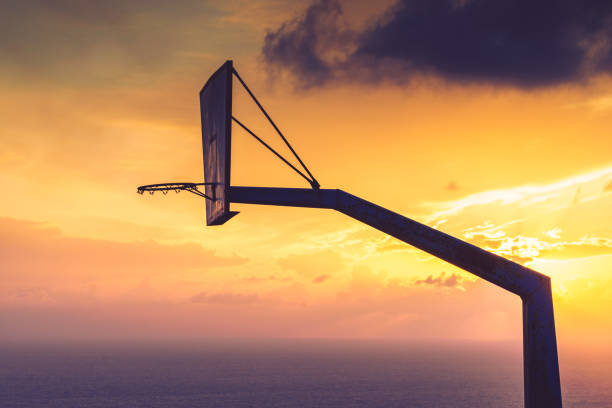 istock basketball basket against sunset sky 996250534