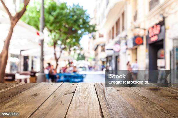 Empty Wooden Table With Defocused Sidewalk Cafe At Background Stock Photo - Download Image Now