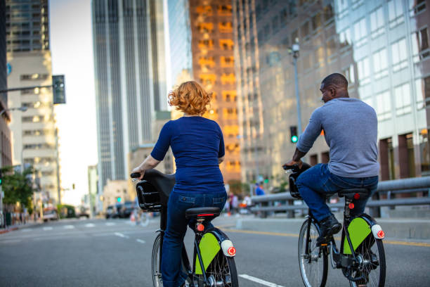 istock Attractive LA Couple Riding Share Bikes 996260656