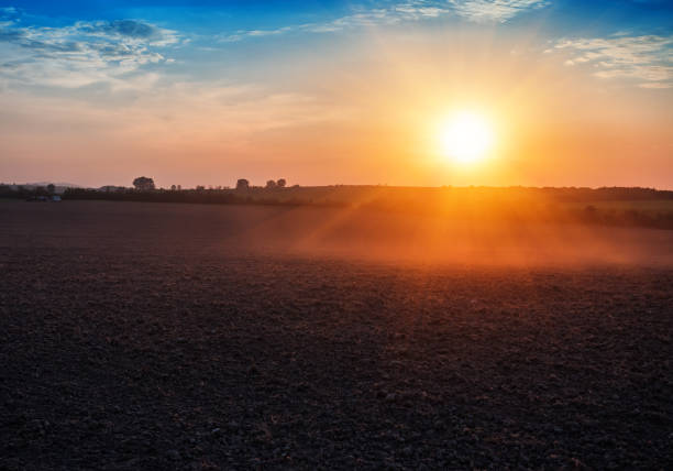 istock plowed field and beautiful sunset 996267630