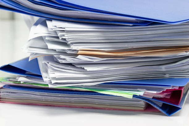 istock file folder and Stack of business report paper 996270806
