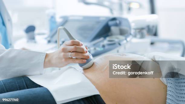 In The Hospital Closeup Shot Of The Doctor Doing Ultrasound Sonogram Scan To A Pregnant Woman Obstetrician Moving Transducer On The Belly Of The Future Mother Stock Photo - Download Image Now