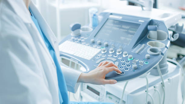 istock In the Hospital, Obstetrician Pushes Buttons on a Control Panel Before Starting Ultrasound / Sonogram Procedure. 996271198