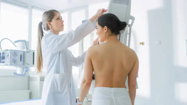 In the Hospital, Female Patients Undergoes Mammogram Screening Procedure Done by Mammography Technologist. Modern Technologically Advanced Clinic with Professional Doctors. Breast Cancer Prevention Screening.