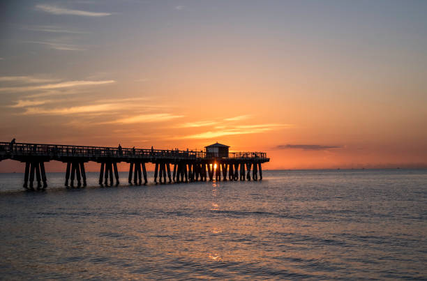 istock Pompano Beach Pier at sunrise with sun and Golden Clouds 996278834