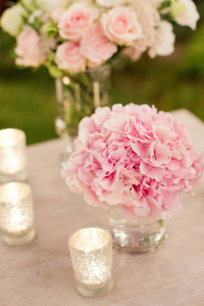 istock pink flowers and burning candles 996285596