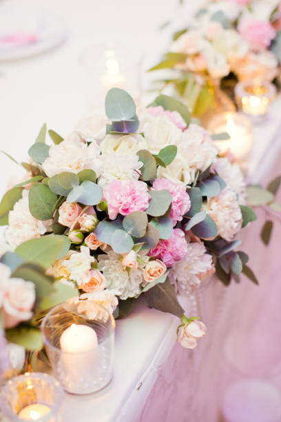 istock flower composition with roses, eucalyptus, chrysantemums in crystal vases 996286354