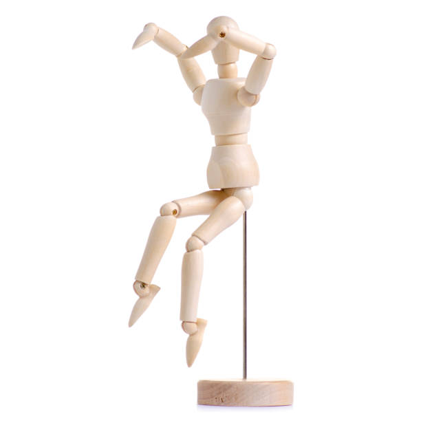 istock Wooden figure of a man exercises 996290522