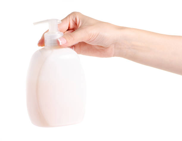 istock White soap bottle with dispenser in hand 996290772