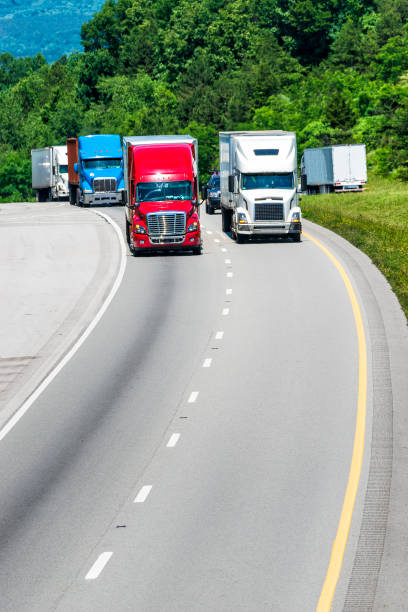 istock Squadron of Heavy Trucks on Interstate with Copy Space 996303794
