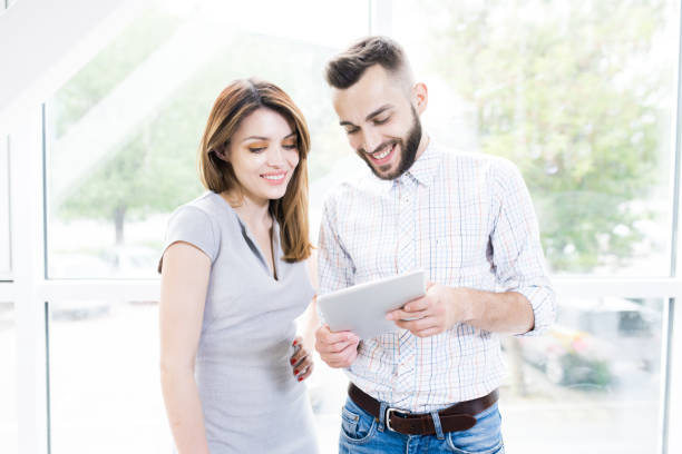 istock Beautiful Business People Standing by Window 996335244