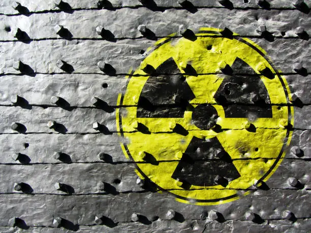 Sign for Radioactivity on a cast iron texture