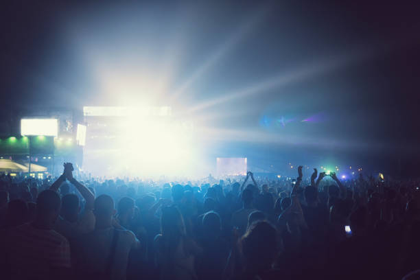istock Cheering Crowd Enjoying at Music Festival 996340194