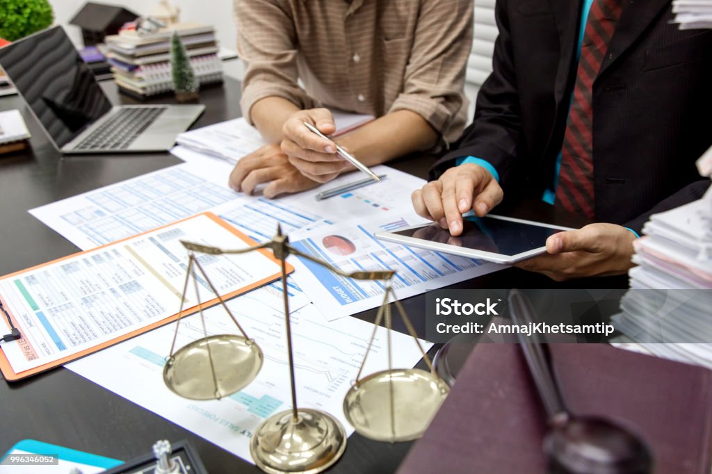 Business lawyer working about legal legislation in courtroom to help their customer Group Of People Stock Photo