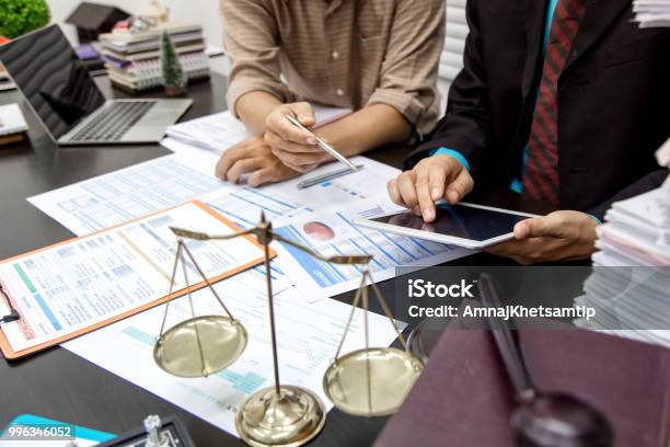 Business Lawyer Working About Legal Legislation In Courtroom To Help Their Customer Stock Photo - Download Image Now