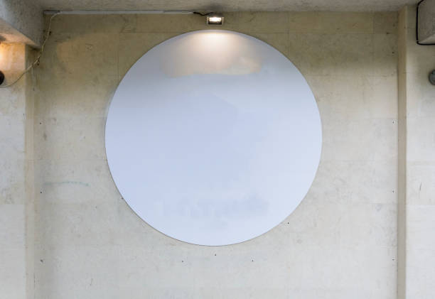 istock Round blank  banner on a wall with lighting,  place for text. 996348424