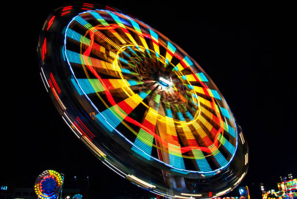 istock The colorful light trail in the fun fair theme park. 996348740