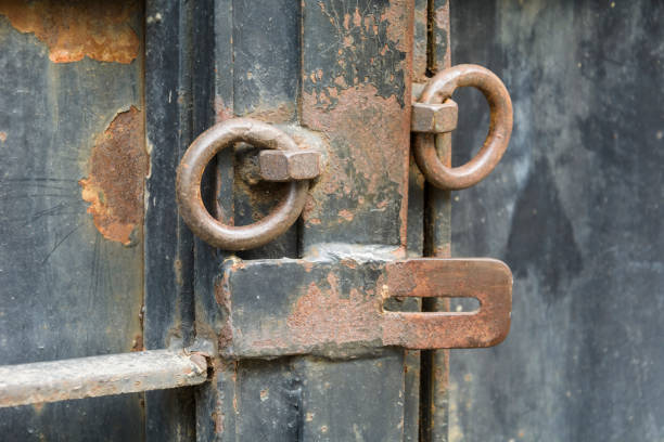 istock iron door with old opened lock with rusty rings. 996348828