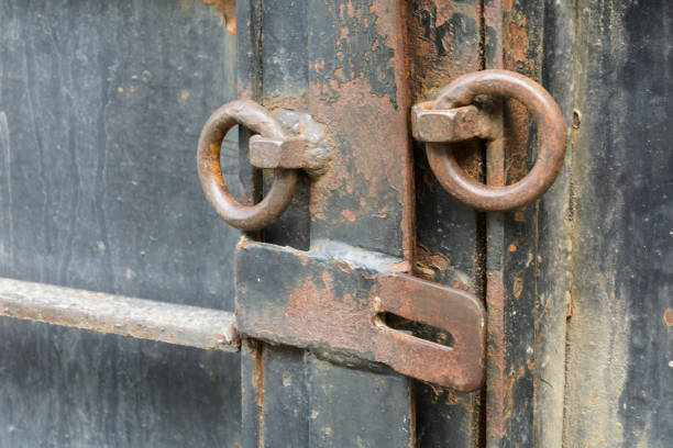 istock iron door with old opened lock with rusty rings. 996348852