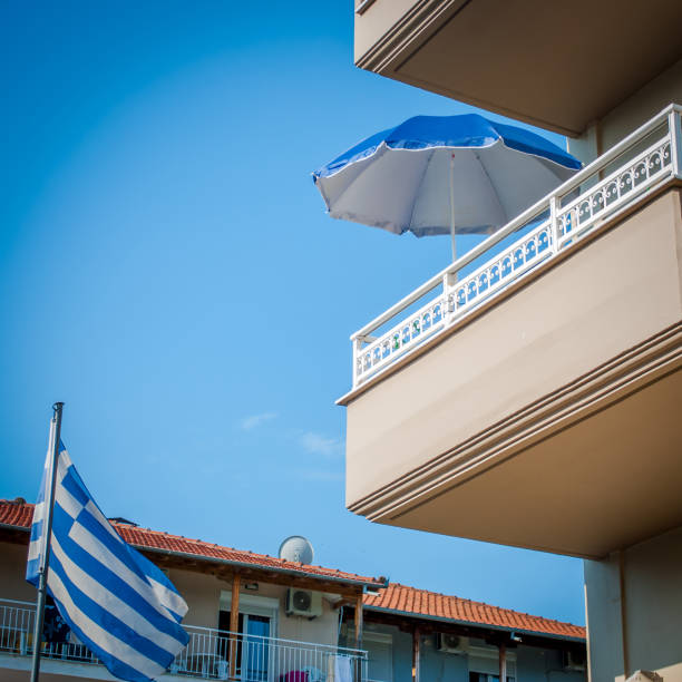 istock Terrace with sunshade and Greek flag 996348876