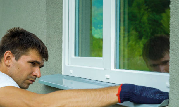 istock Man worker in protective gloves measuring external frame and PVC window metal sill size 996365526
