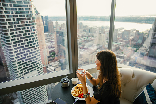 Women have breakfast by amazing city view