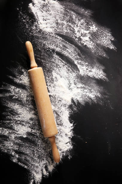 istock Baking background with the rolling pin with flour. On the dark table. Free space for text 996368836