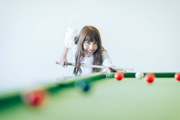 istock Beautiful woman playing snooker 996371720