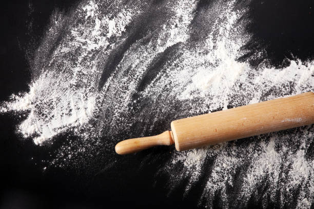 istock Baking background with the rolling pin with flour. On the dark table. Free space for text 996372138