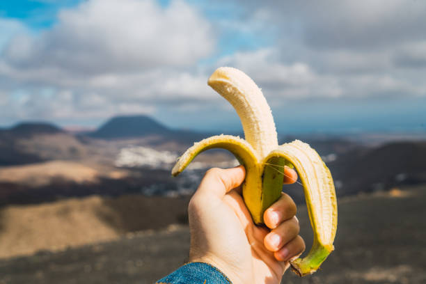 istock Person eating banana on mountain 996393878