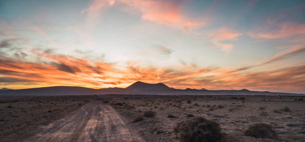istock Road and mountains in evening 996394248