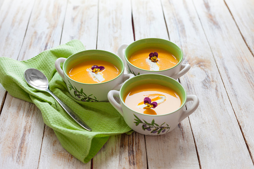 Puree soup, made from orange pumpkin, sweet potatoes and carrots, served with sour cream