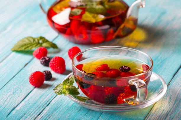 istock raspberry berry tea kettle cup fresh wooden 996405214