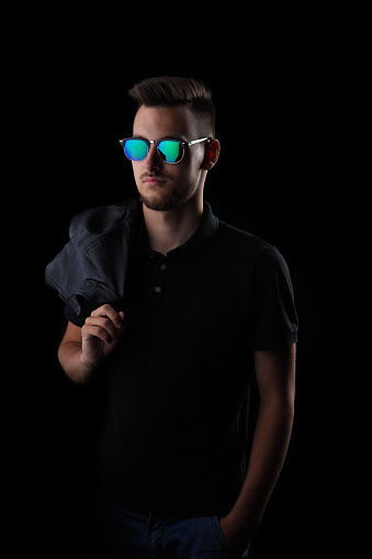 young man with sunglasses on a black background